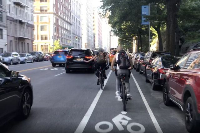 Cyclists riding up to last night's community board meeting, forced into traffic by a cab blocking the painted bike lane on Central Park West.